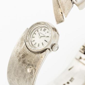 Aftonklocka/armring, Bo Dolk, 18K vitguld med briljantslipade diamanter, 1970-tal.