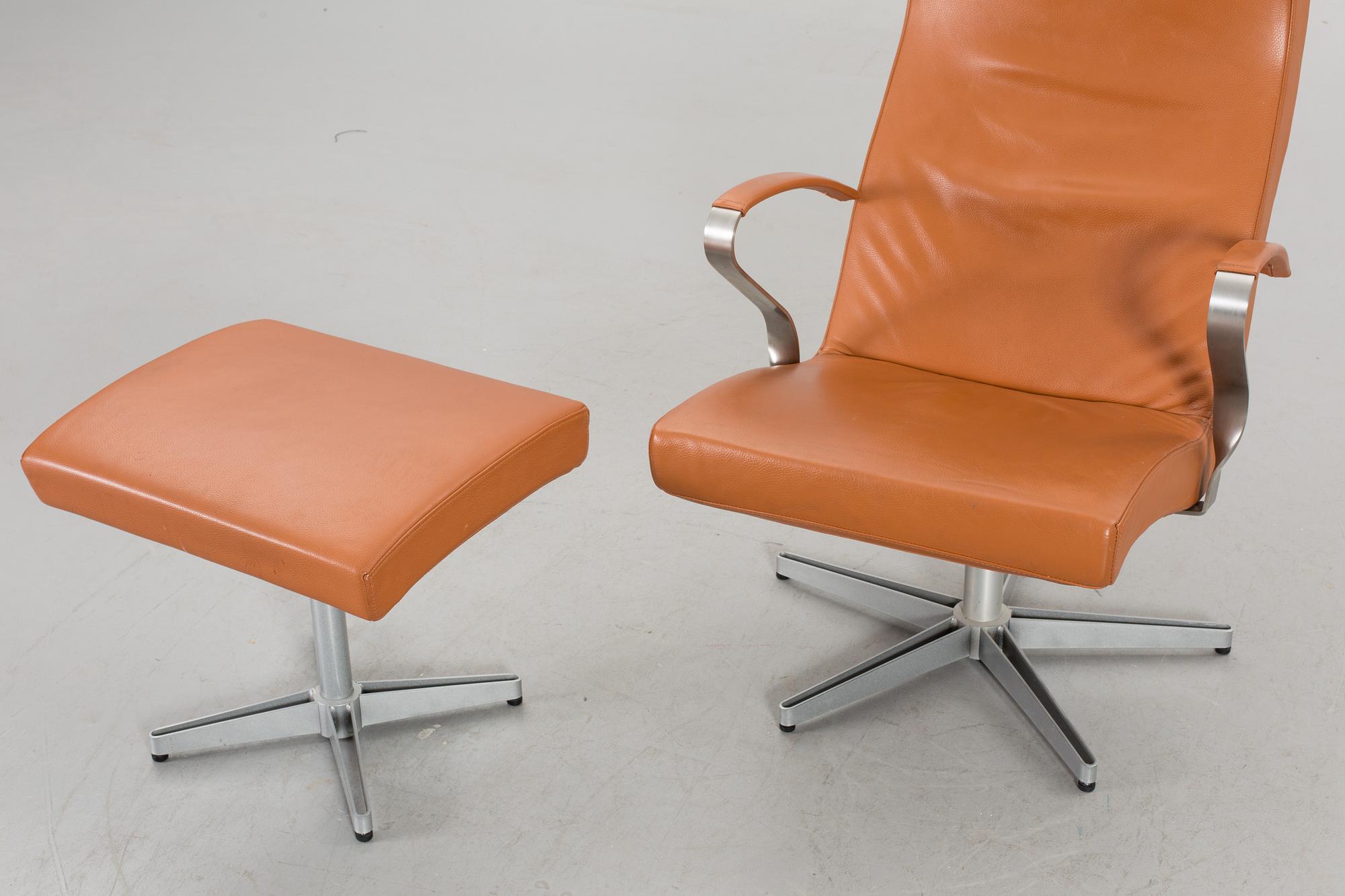 AN ARMCHAIR WITH STOOL MODEL "TWIST" DESIGNED BY JERKER ANDERSSON FOR SÖDERBERGS MÖBLER.