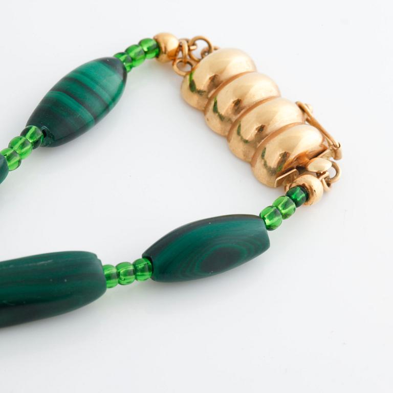 A malakite and green paste necklace.