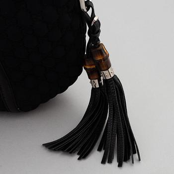 Gucci, a black neoprene handbag.