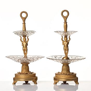 A pair of French Empire early 19th century gilt bronze and glass centre pieces in the manner of Pierre Philippe Thomire.