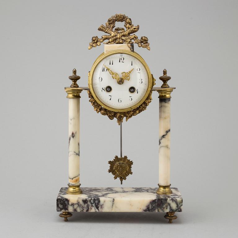A marble and brass pendulum clock, first half of the 20th century.