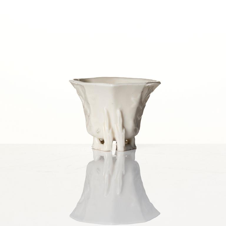 A lacquer tea box and a blanc de chine cup, Qing dynasty 18/19th century.