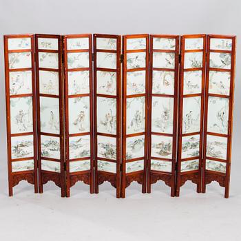 870. A Chinese folding screen with 48 porcelain tiles, late Qing dynasty, signed Ren Huanzhang, and dated 1881.