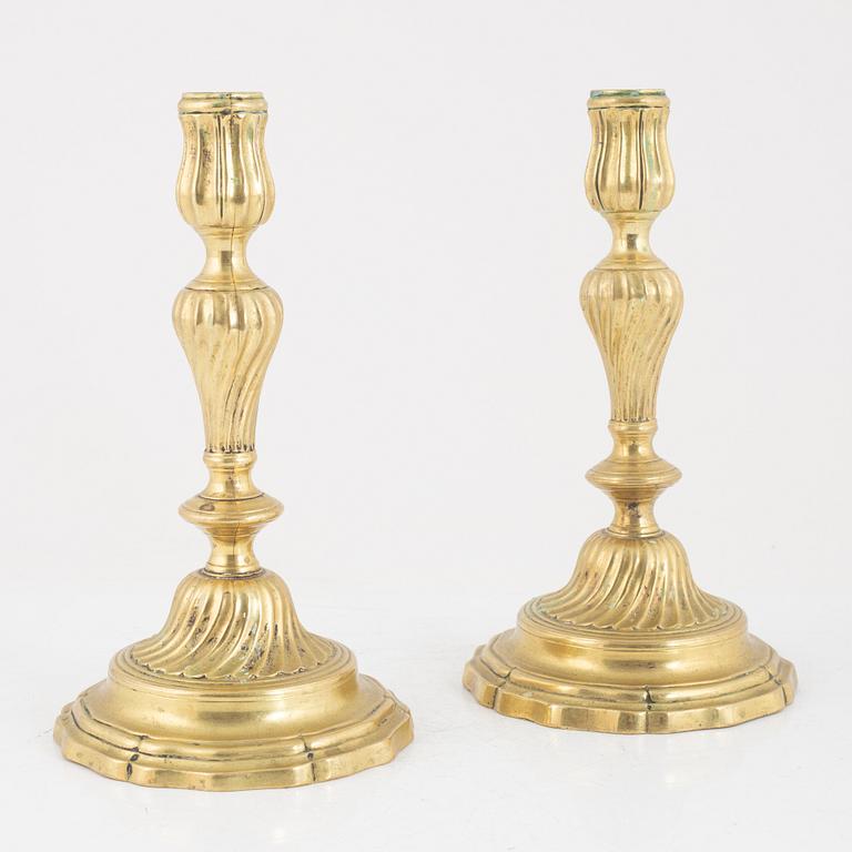 A pair of French Louis XV brass candlesticks, mid 18th century.