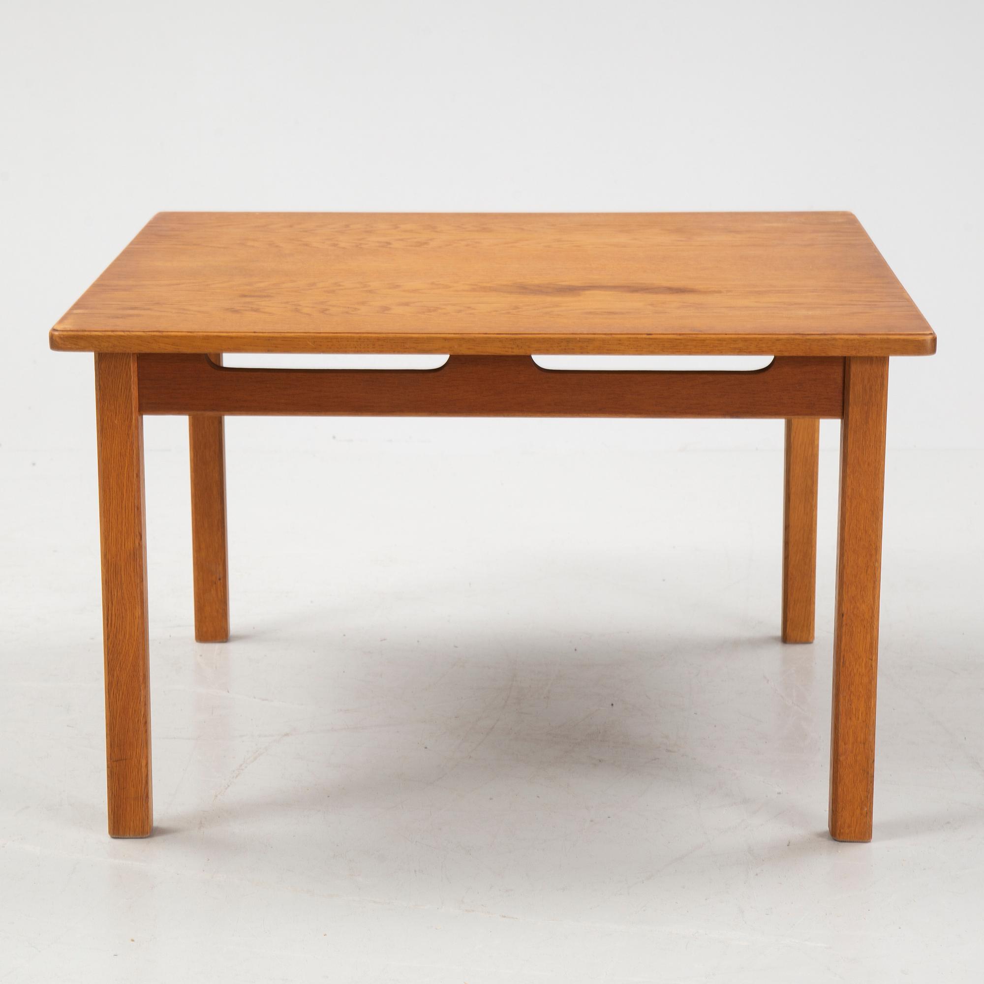An oak coffee table with a later travertine top.