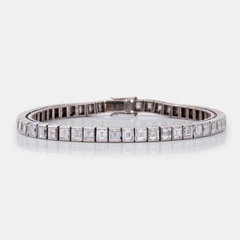 A square step-cut diamond line bracelet. Total carat weight 12.80 cts.