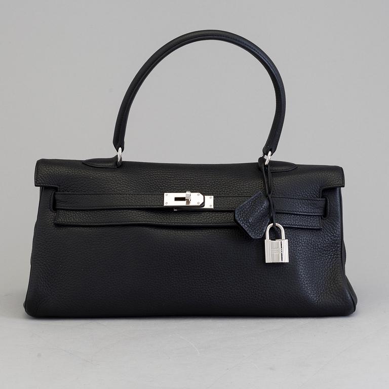 A black togo "JPG Shoulder Kelly 42" by Hermès 2009.