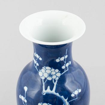 A Chinese porcelain dragon bowl, Qing dynasty, 19th century, and a blue and white porcelain vase, China, 20th century.