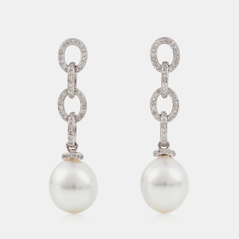 A pair of oval cultured South sea pearl and brilliant-cut diamond earrings. Pearls 12.5 - 15 mm.