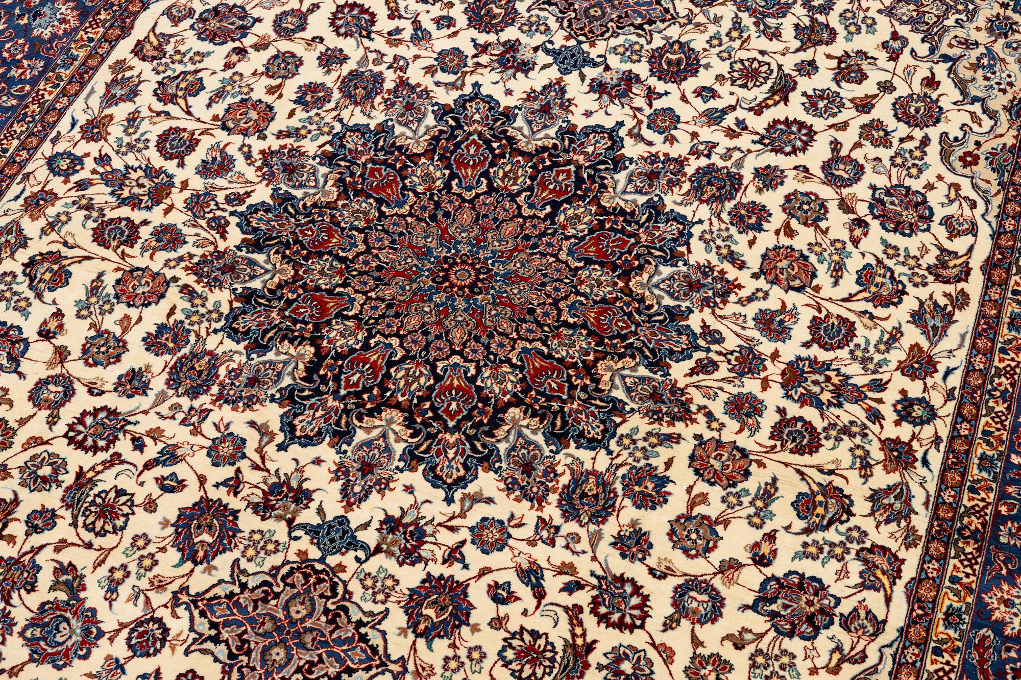 A semi-antique Isfahan carpet, Central Persia, signed (Ali) Seirafian, 328 x 250 cm.