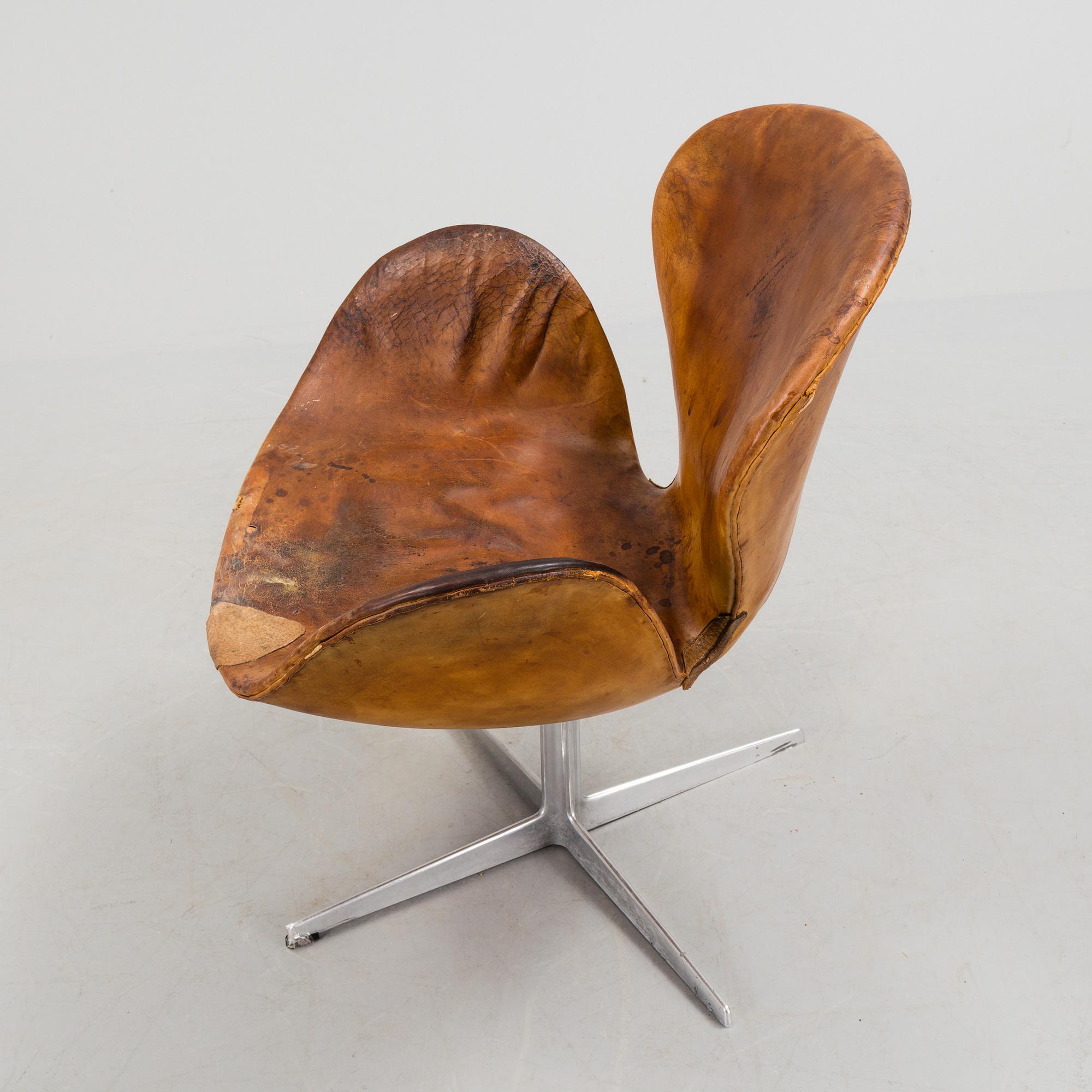 An Arne Jacobsen steel and brown leather 'Swan' chair, Fritz Hansen, Denmark 1960's.