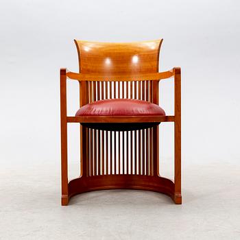 A cherry wood model 606 'Barrel' chair by Frank Lloyd Wright from Cassina.
