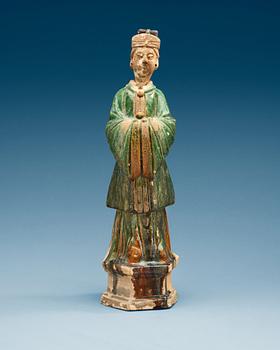 1422. A green glazed pottery figure of a dignitary, Ming dynasty (1368-1644).