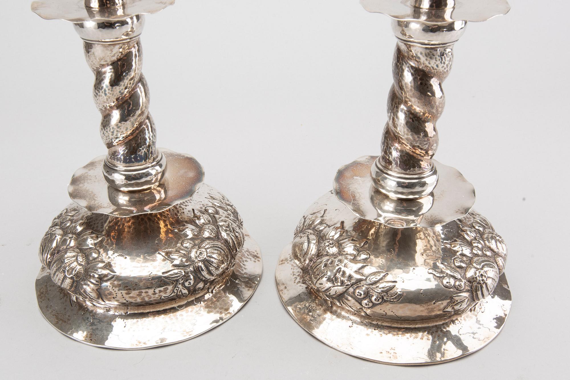 A pair of silver baroquestyle candlesticks. W.H.H, Stockholm. 1935. Filled foot.