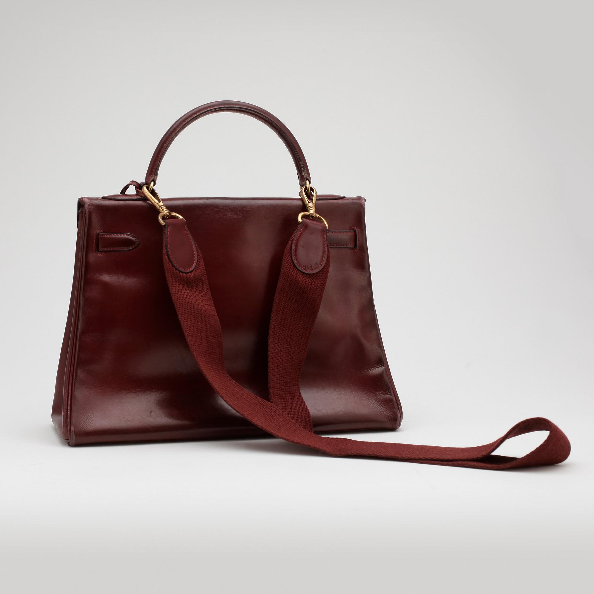 HERMÈS, a burgundy read leather "Kelly 32" bag, 1960's.