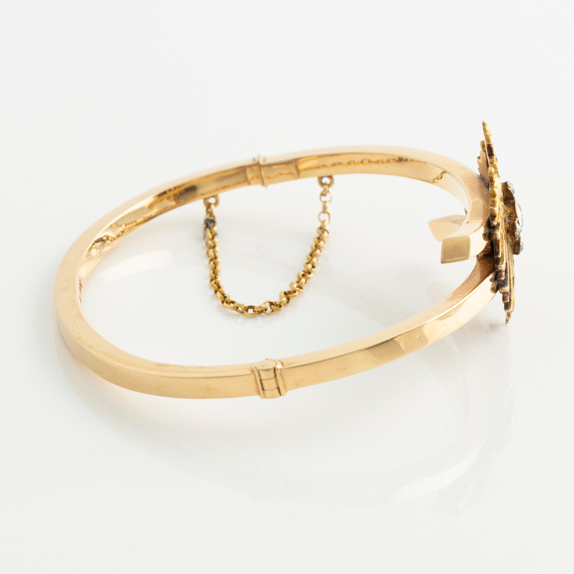 Armband 18K guld med en fastlödd del av en broschnål i guld med gammalslipade diamanter, i form av en örn.