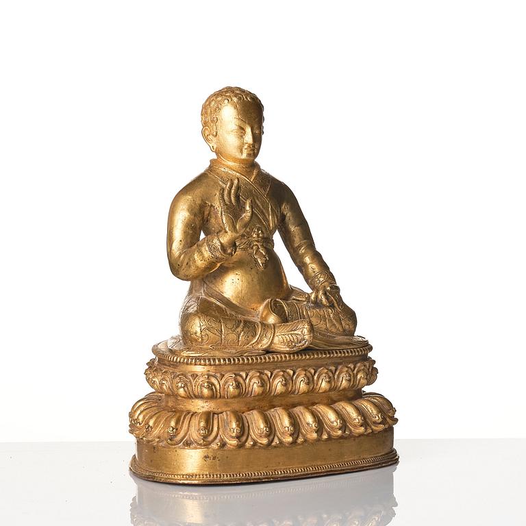 A gilt copper alloy figure of a Lama, most likely Sonam Tsemo, Tibet, probably 16/17th century.