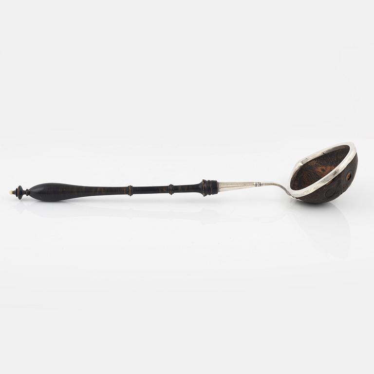 A silver mounted soup ladle with a coconut cup.