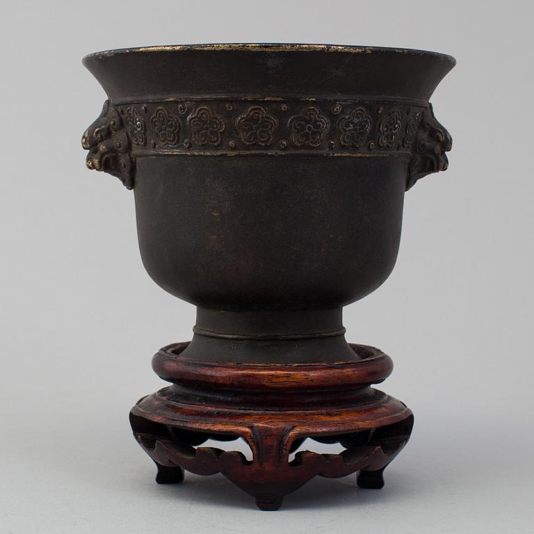 A chinese bronze incense burner and wooden stand, ca 1900s.