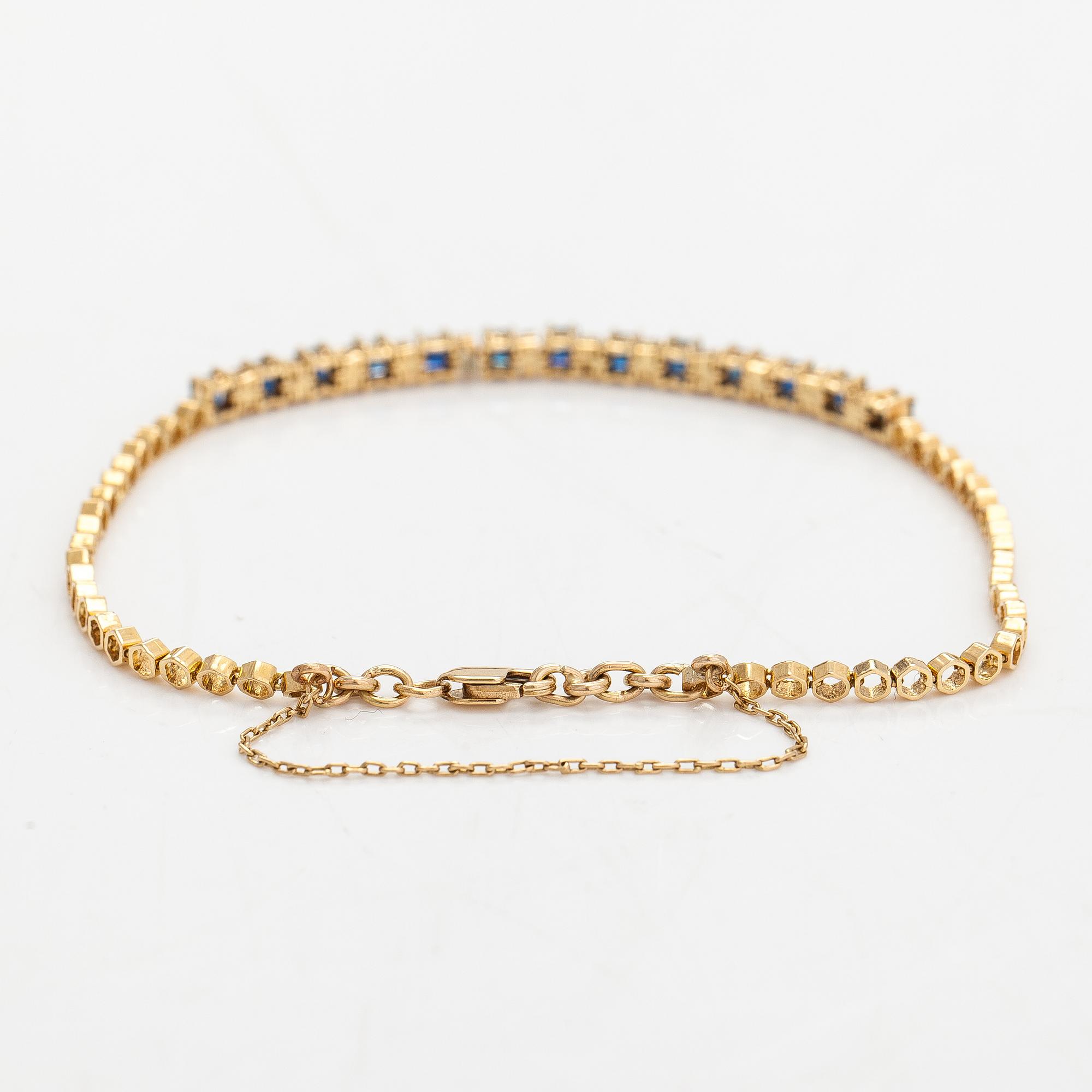 Rannkoru, 14K kultaa, timantteja n. 0.12 ct yht ja safiireja.