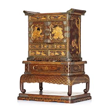 A Japanese lacquer cabinet on a stand, Meiji period (1868-1912).