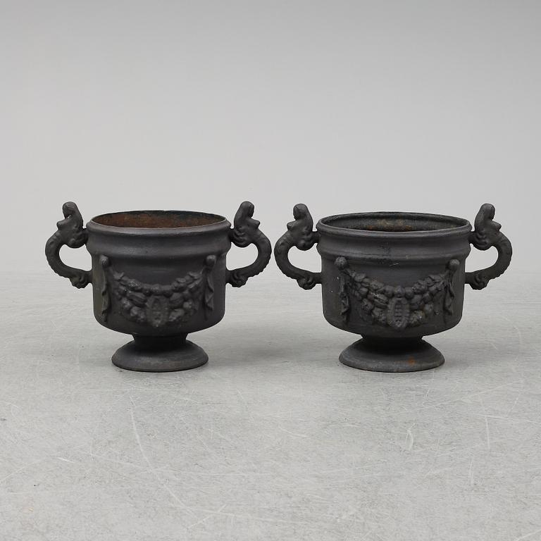 Two 20th Century cast iron flower pots.