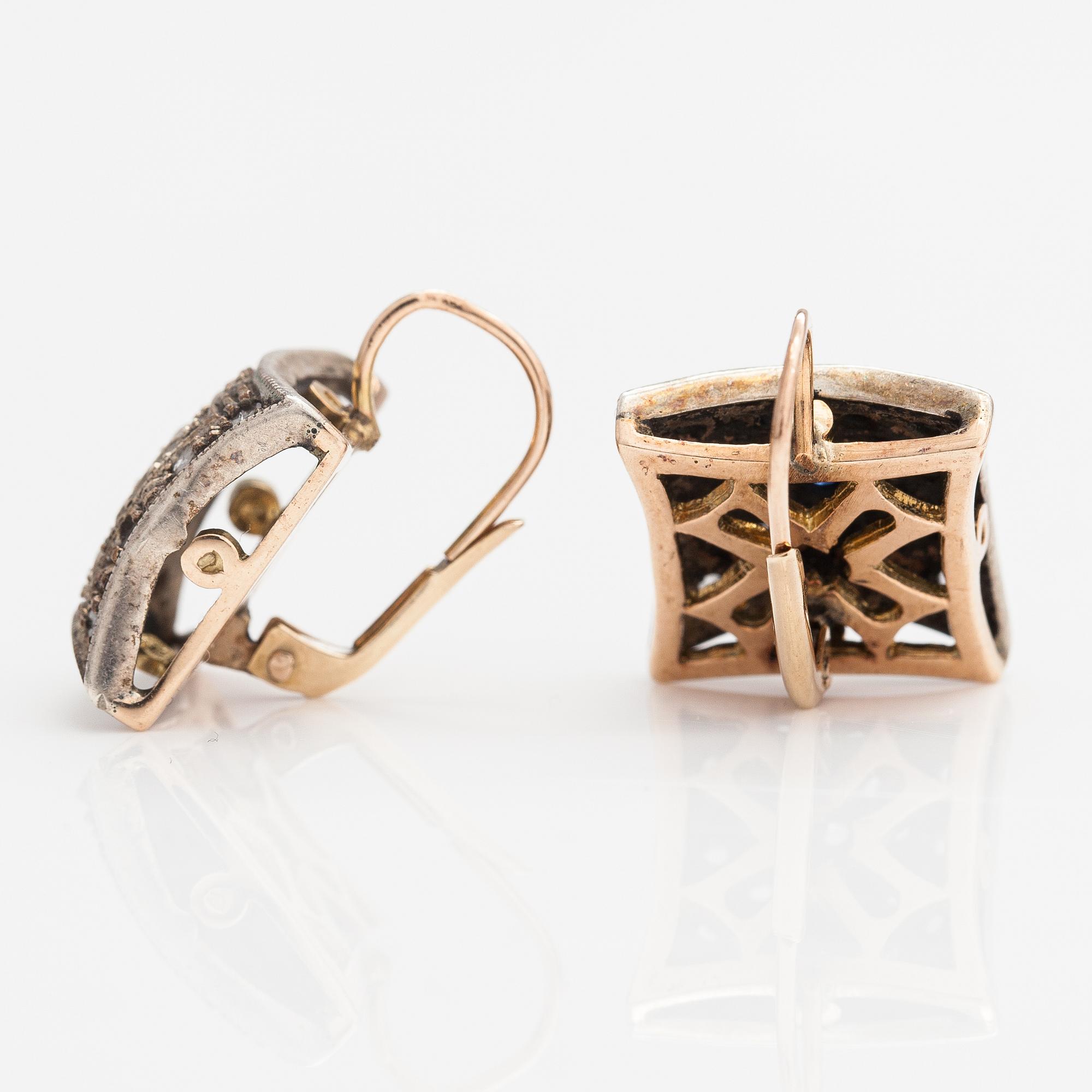 A pair of 14K gold earrings with rose-cut diamonds and sapphires.