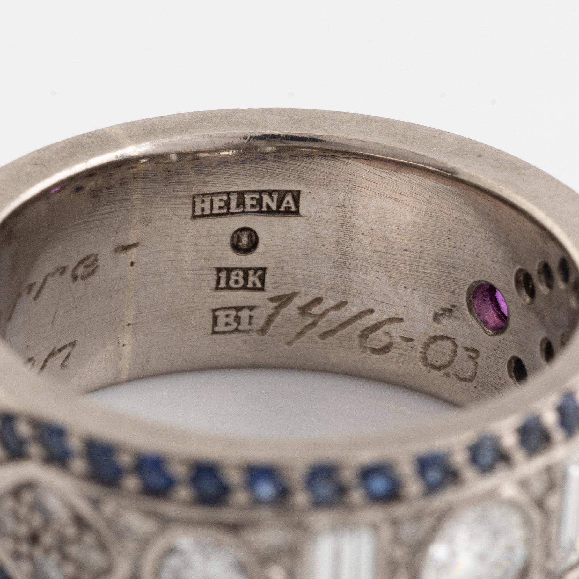 An 18K white gold ring set with diamonds, rubies and sapphires.