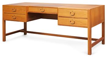 672. A Josef Frank walnut desk by Svensk Tenn, the front with five drawers, the backwith a bookshelf.
