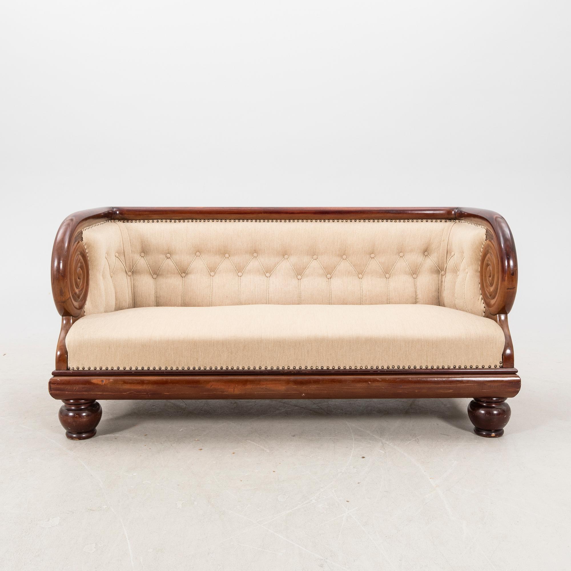An early 1900s Art deco walnut sofa.