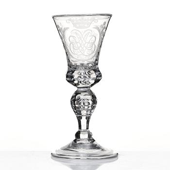 A cut and engraved glass goblet, dated 1755.