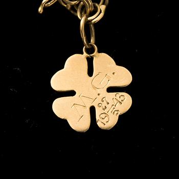 ARMLÄNK,  18 k guld med berlock. G A Dahlgren AB Malmö, 1940. Bolidenguld. Vikt ca 5,5 g.