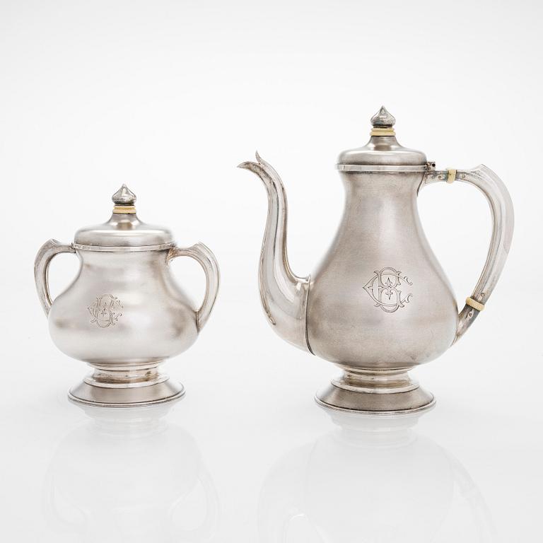 A four-piece silver coffee set, St. Petersburg 1887, original fitted box from Khlebnikov. Sugar tong, Moscow around 190.