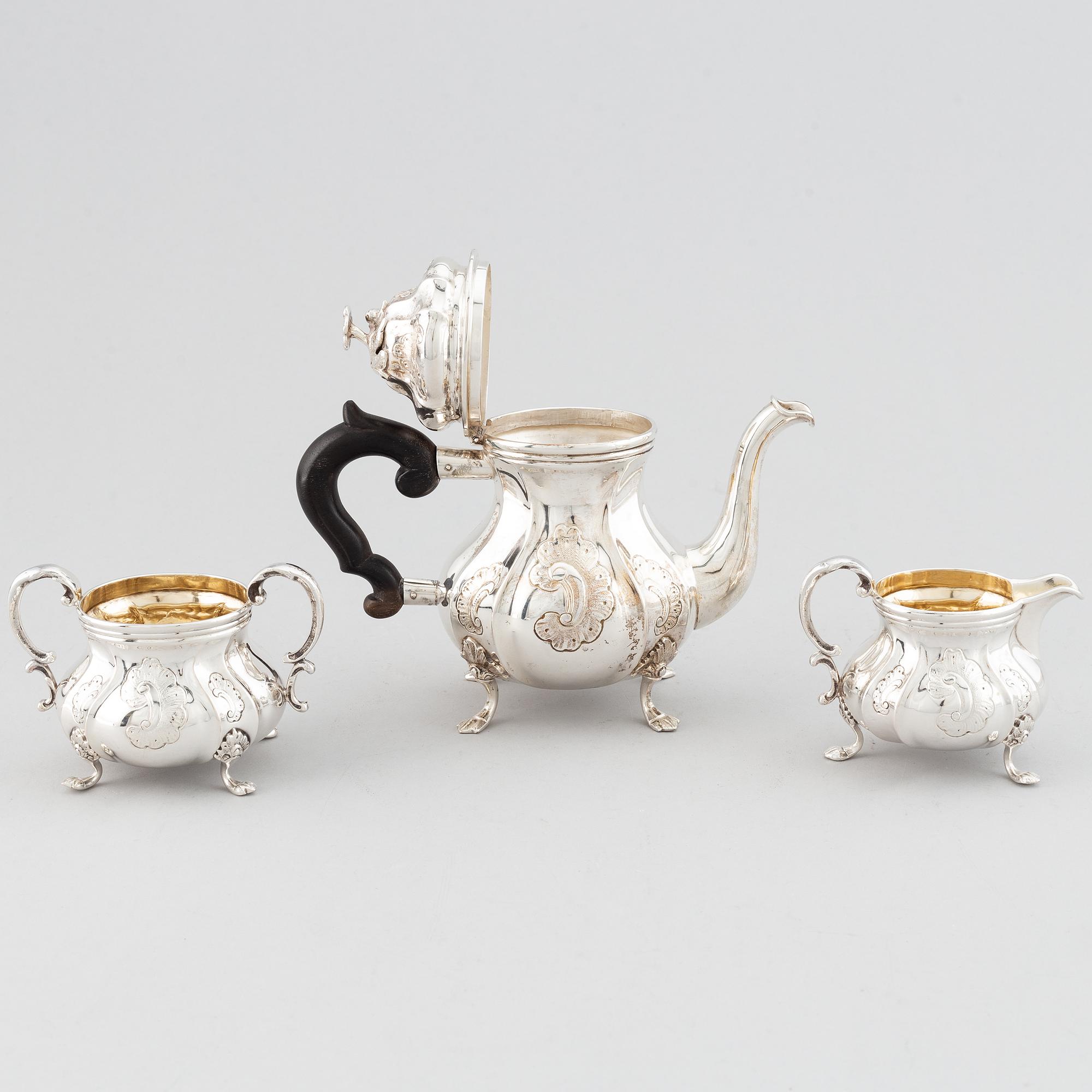An early 20th century Rococo-style parcel gilt and silver three part coffee service.