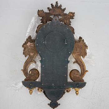 A Gustavian style wall clock, circa 1900.