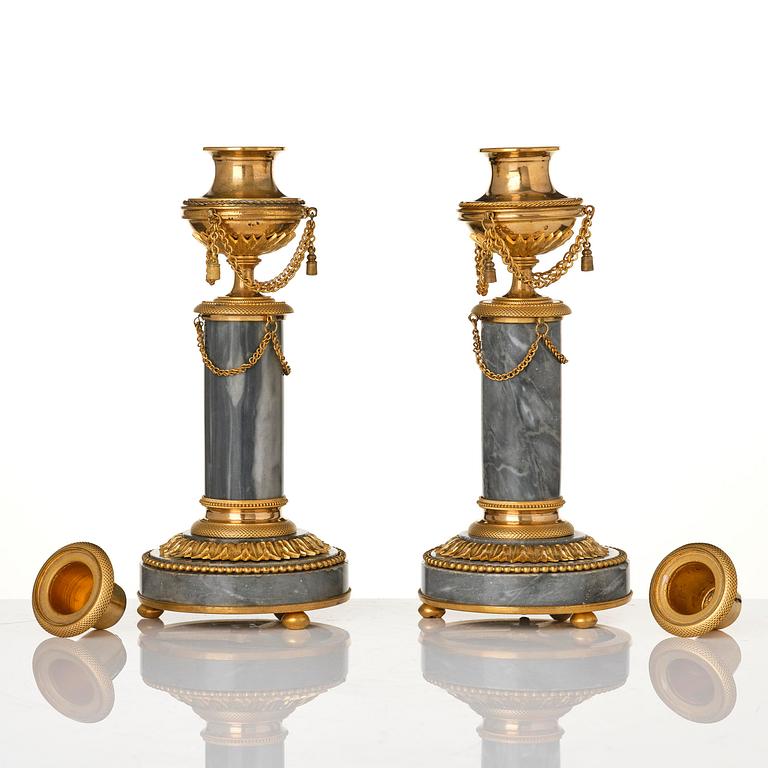 A pair of Louis XVI ormolu and Bleu turquin candlesticks.
