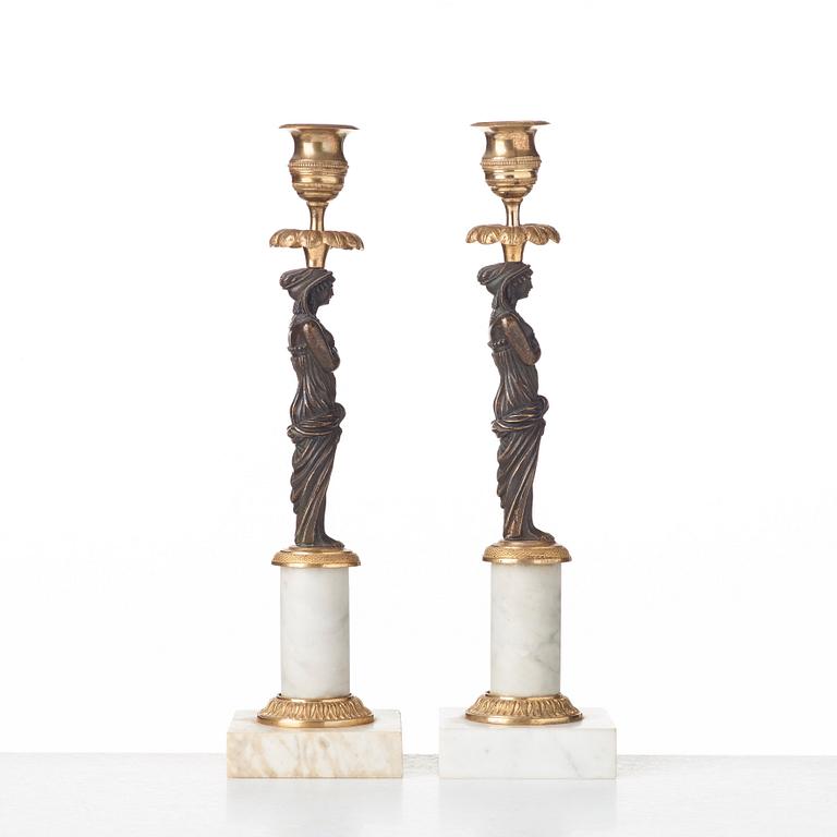 A pair of late Gustavian circa 1800 white marble and bronze candlesticks.