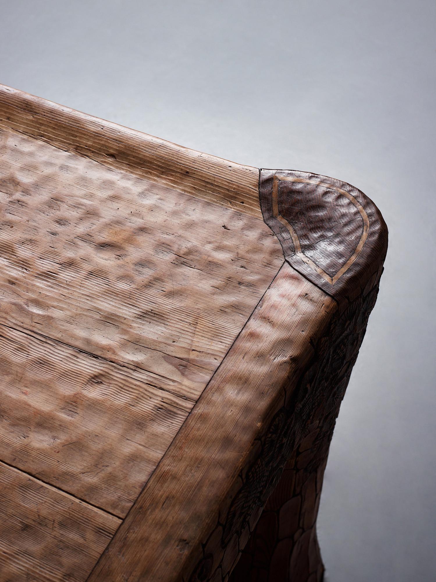 Gustaf Fjaestad, an Art Nouveau carved pine table, Arvika Sweden 1914, a double to the table in the Thiel Collection,