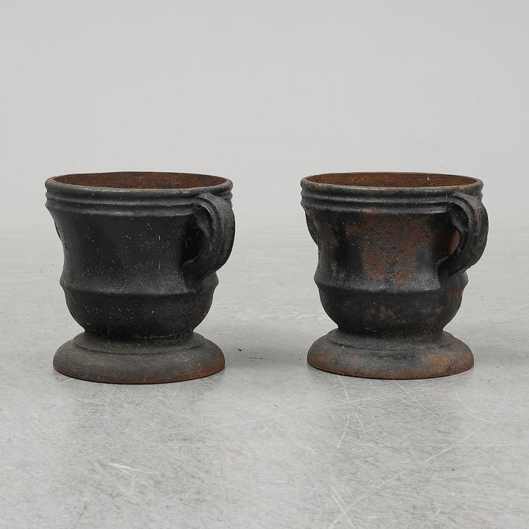 A 19th  century pair of cast iron flower pots.