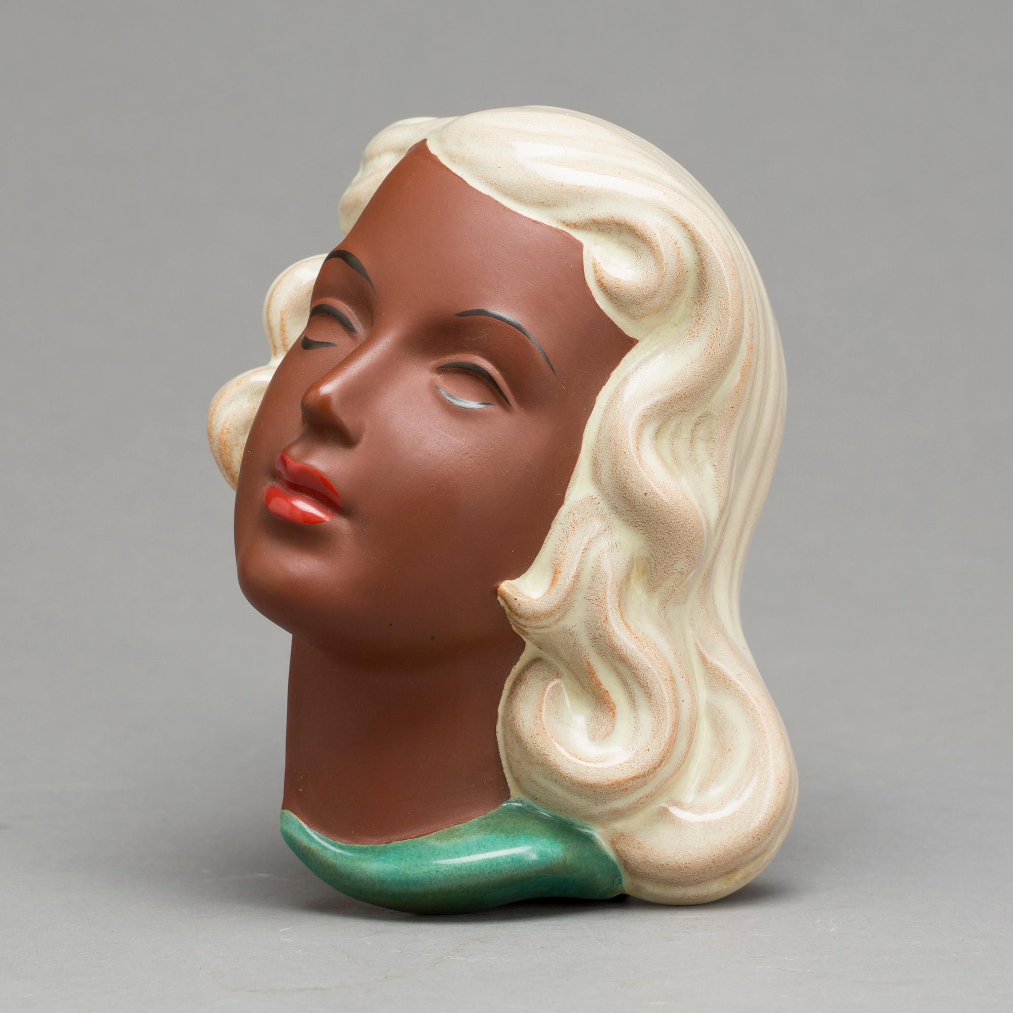 An Adolf Prischl terracotta wall mask for Goldscheider, mid 1900.