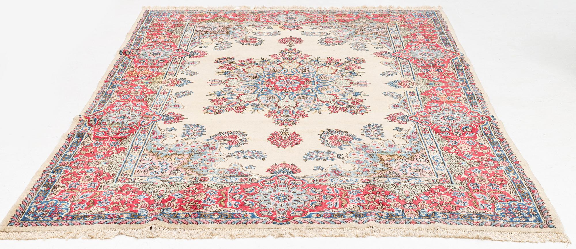 A carpet, old Kerman, approx. 314 x 210 cm.