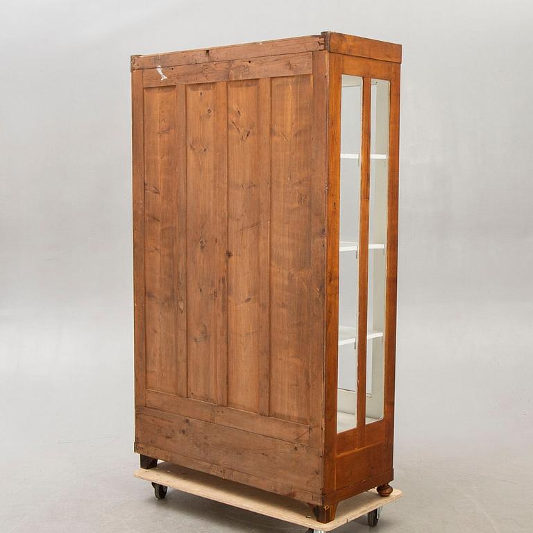 An early 1900s walnut display cabinet.