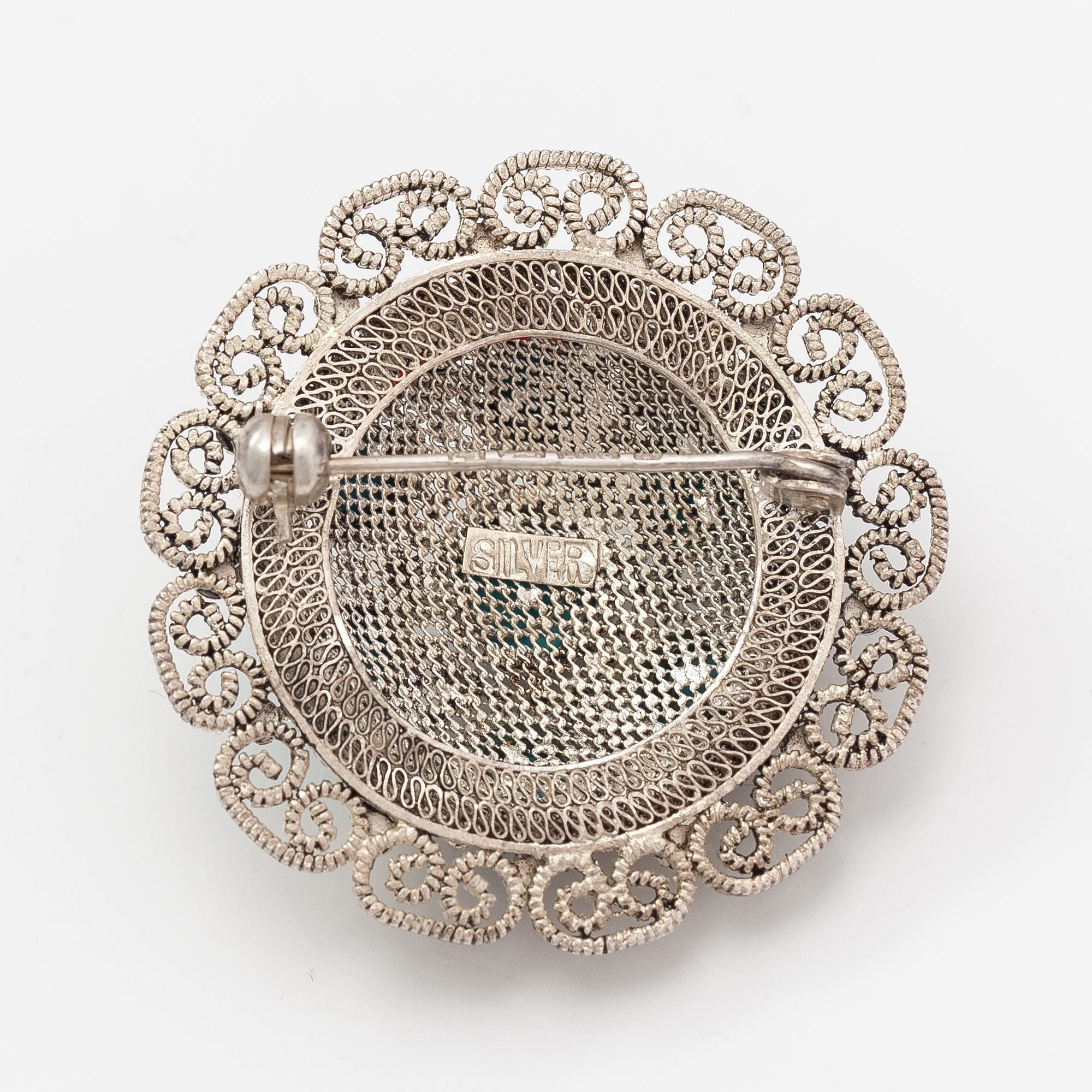 A silver bracelet and ring with turquoises. China.