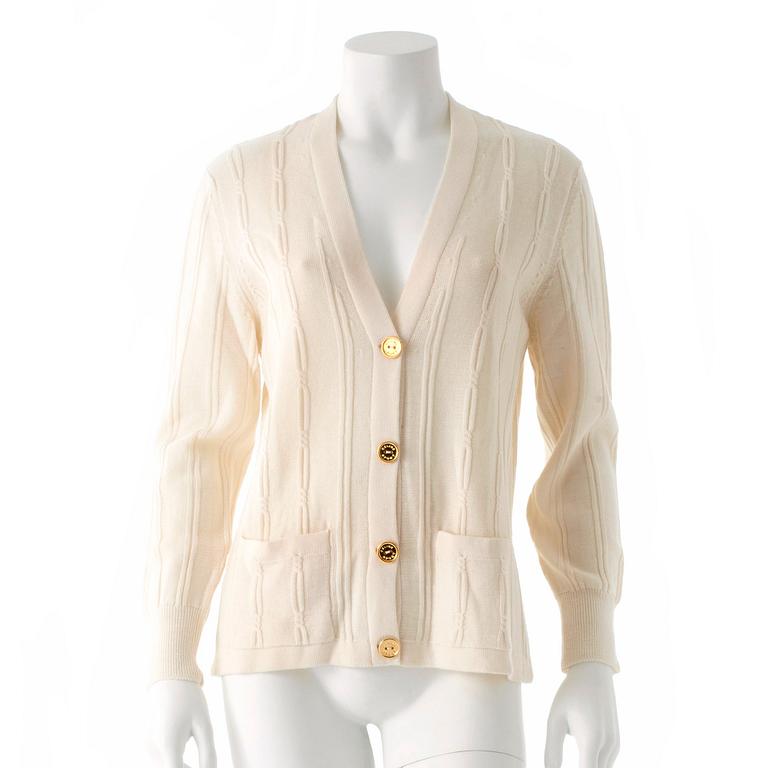 CÉLINE, a white wool cardigan.