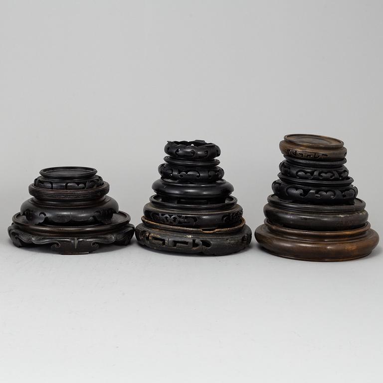 A set of 22 Chinese wooden stands, mostly 20th Century.