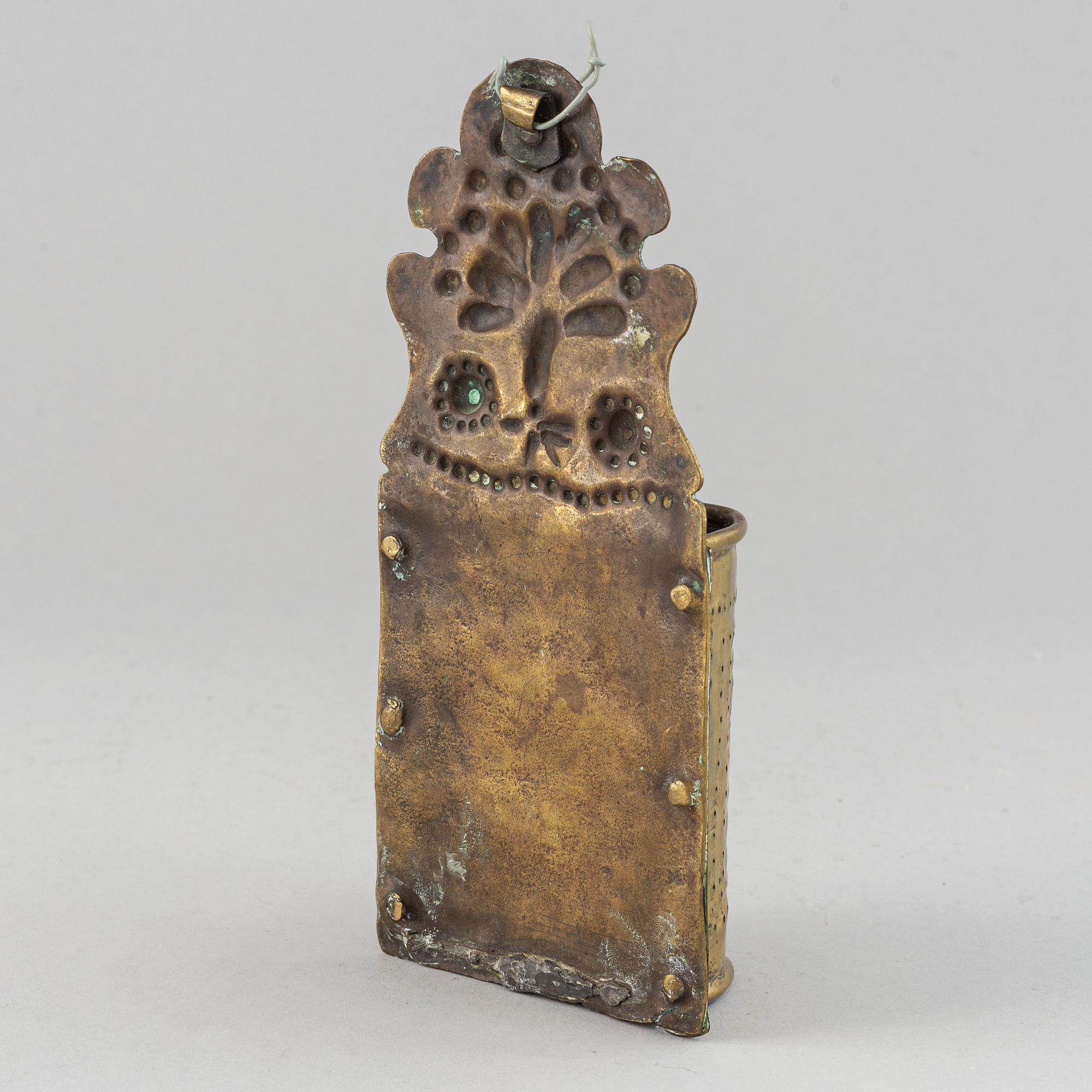 A 17th century brass spoon holder.