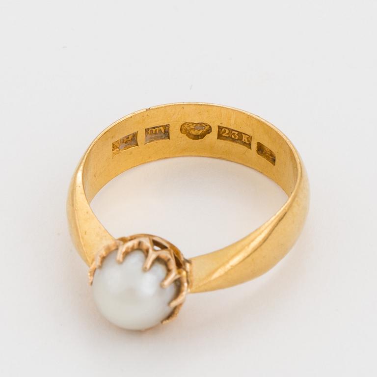 A ring set with a cultured, mabé pearl.