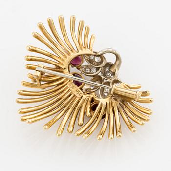 Brooch/pendant in 18K gold with rubies, garnets, and octagon-cut diamonds.