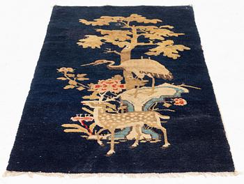 A Rug, a semi-antique Baotou figural, China, ca 127-128 x 67,5 cm.